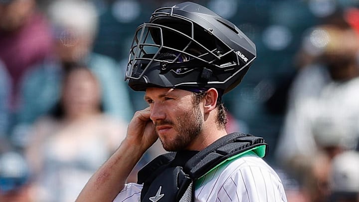 Colorado Rockies catcher Braxton Fulford (37) is adjusting ear piece. 