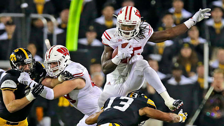 Wisconsin Badgers running back Melvin Gordon picks up three yards, leaping over Iowa Hawkeyes defensive back Greg Mabin during Wisconsin's 26-24 win over Iowa at Kinnick Stadium in Iowa, City, Iowa, Saturday, November 22, 2014.