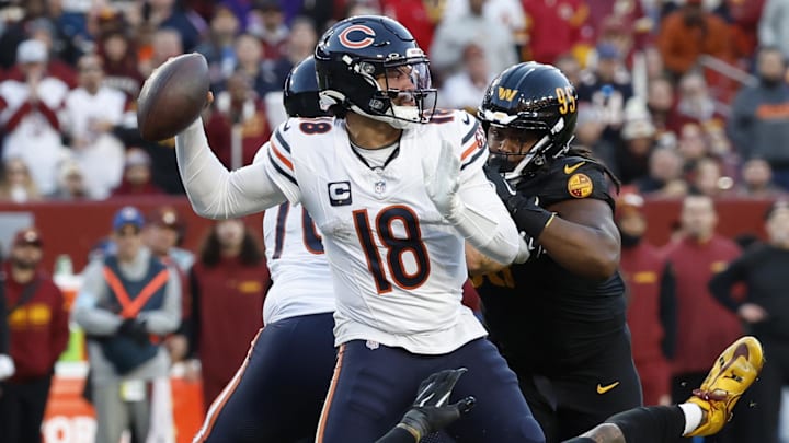 Chicago Bears quarterback Caleb Williams (18) passes the ball as Washington Commanders linebacker Frankie Luvu (4) and Commanders linebacker Bobby Wagner (54) defend during the second quarter at Northwest Stadium.