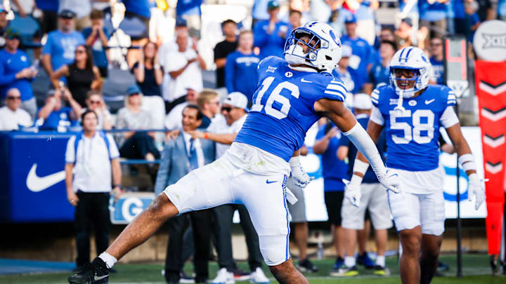 BYU linebacker Isaiah Glasker returns an interception for a touchdown against Arizona BYU linebacker Isaiah Glasker returns an interception for a touchdown against Arizona