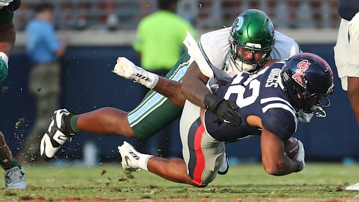 Sep 20, 2025; Oxford, Mississippi, USA; Tulane Green Wave defensive linemen Eliyt Nairne (90) tackles Mississippi Rebels running back Logan Diggs (22) during the fourth quarter at Vaught-Hemingway Stadium. Mandatory Credit: Petre Thomas-Imagn Images