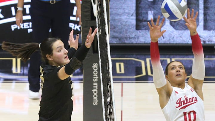 Indiana setter Camryn Haworth (10) hits the ball over the net to Purdue outside hitter Eva Hudson (17) Indiana setter Camryn Haworth (10) hits the ball over the net to Purdue outside hitter Eva Hudson (17)