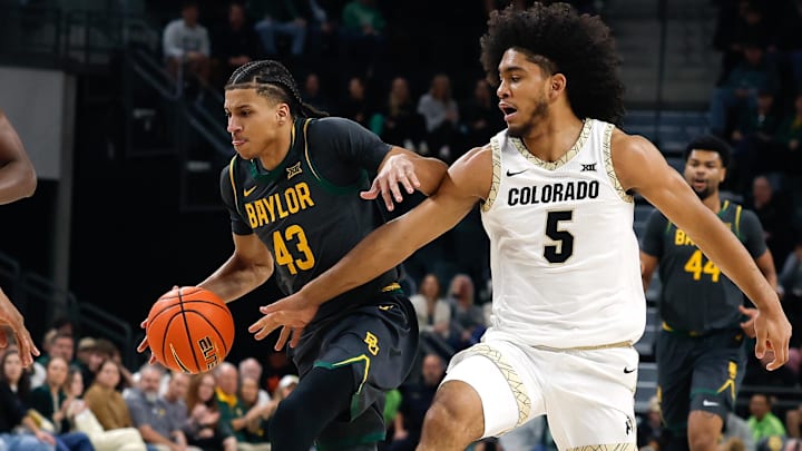 Feb 4, 2026; Waco, Texas, USA;  Baylor Bears guard Cameron Carr (43) drives to the basket past Colorado Buffaloes guard Josiah Sanders (5) during the first half at Paul and Alejandra Foster Pavilion.