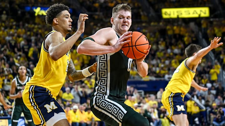 Michigan State's Jaxon Kohler, right, moves to the basket as Michigan's Yaxel Lendeborg defends during the second half on Sunday, March 8, 2026, at the Crisler Center in Ann Arbor.