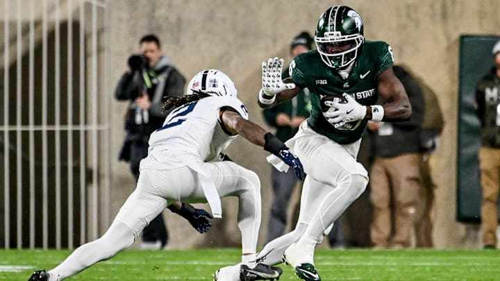 Michigan State's Nick Marsh, right, catches a pass as Penn State's Audavion Collins closes in during the third quarter on Saturday, Nov. 15, 2025, at Spartan Stadium in East Lansing.