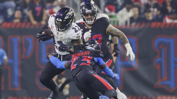 Dec 25, 2024; Houston, Texas, USA; Baltimore Ravens running back Derrick Henry (22) rushes against Houston Texans safety Eric Murray (23) in the second half at NRG Stadium. Mandatory Credit: Thomas Shea-Imagn Images Dec 25, 2024; Houston, Texas, USA; Baltimore Ravens running back Derrick Henry (22) rushes against Houston Texans safety Eric Murray (23) in the second half at NRG Stadium. Mandatory Credit: Thomas Shea-Imagn Images