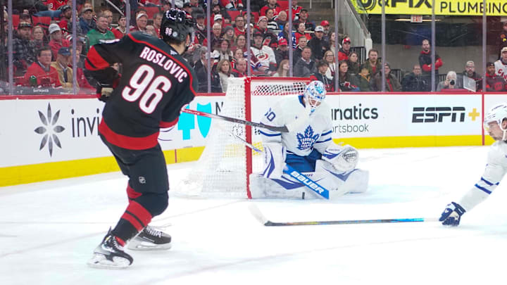 Jan 9, 2025; Raleigh, North Carolina, USA;  Toronto Maple Leafs goaltender Joseph Woll (60) stops the scoring attempt by Carolina Hurricanes center Jack Roslovic (96) during the first period at Lenovo Center. Mandatory Credit: James Guillory-Imagn Images