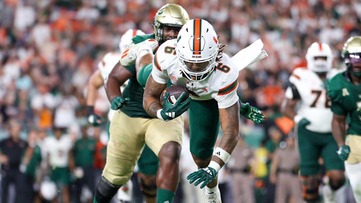 Sep 21, 2024; Tampa, Florida, USA; Miami Hurricanes running back Damien Martinez (6) dives into the end zone for a two point conversion against the South Florida Bulls in the second quarter at Raymond James Stadium. Mandatory Credit: Nathan Ray Seebeck-Imagn Images Sep 21, 2024; Tampa, Florida, USA; Miami Hurricanes running back Damien Martinez (6) dives into the end zone for a two point conversion against the South Florida Bulls in the second quarter at Raymond James Stadium. Mandatory Credit: Nathan Ray Seebeck-Imagn Images