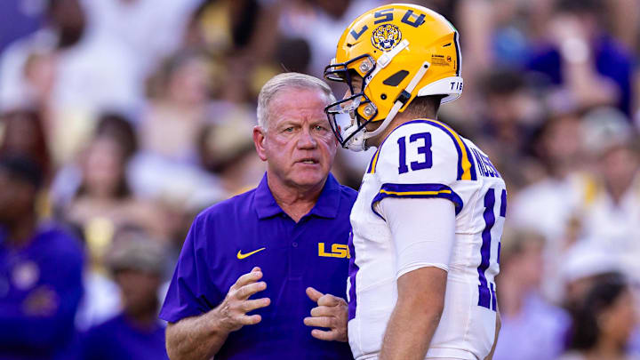 Sep 28, 2024; Baton Rouge, Louisiana, USA;  LSU Tigers quarterback Garrett Nussmeier (13) talks to head coach Brian Kelly during warmups before a game against the South Alabama Jaguars at Tiger Stadium. Mandatory Credit: Stephen Lew-Imagn Images