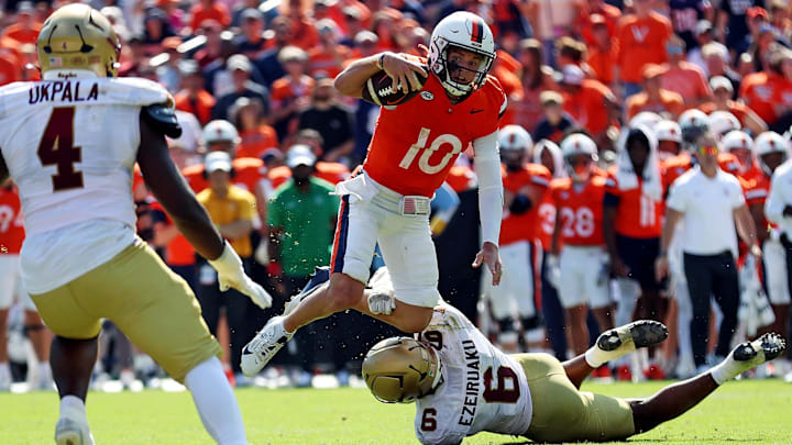Oct 5, 2024; Charlottesville, Virginia, USA; Virginia Cavaliers quarterback Anthony Colandrea (10) is tackled by Boston College Eagles defensive end Donovan Ezeiruaku (6) during the third quarter at Scott Stadium. Mandatory Credit: Peter Casey-Imagn Images Oct 5, 2024; Charlottesville, Virginia, USA; Virginia Cavaliers quarterback Anthony Colandrea (10) is tackled by Boston College Eagles defensive end Donovan Ezeiruaku (6) during the third quarter at Scott Stadium. Mandatory Credit: Peter Casey-Imagn Images