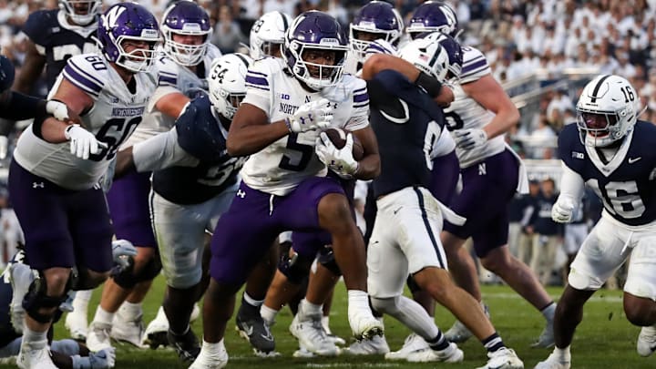 Northwestern Wildcats running back Caleb Komolafe (5) runs for a touchdown during the fourth quarter against the Penn State Nittany Lions at Beaver Stadium.