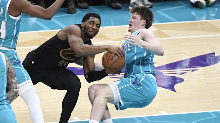 Jan 21, 2026; Charlotte, North Carolina, USA;  Cleveland Cavaliers guard Donovan Mitchell (45) collides into Charlotte Hornets forward Kon Knueppel (7) during the second half at the Spectrum Center. Mandatory Credit: Sam Sharpe-Imagn Images
