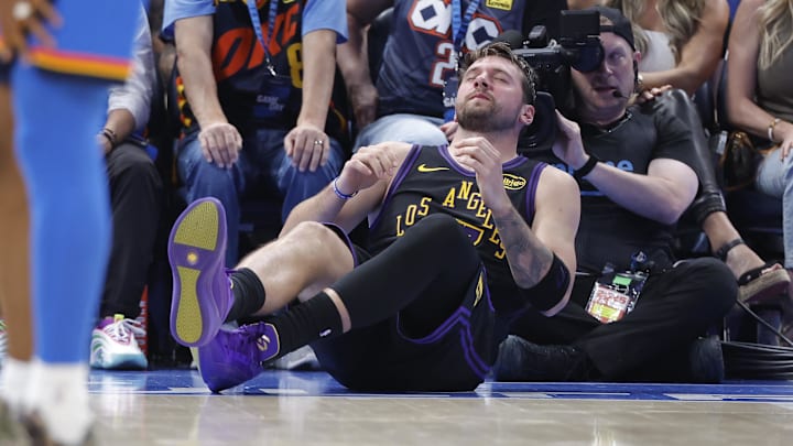 Apr 2, 2026; Oklahoma City, Oklahoma, USA; Los Angeles Lakers guard Luka Doncic (77) falls to the court during a play against the Oklahoma City Thunder during the third quarter at Paycom Center. Mandatory Credit: Alonzo Adams-Imagn Images