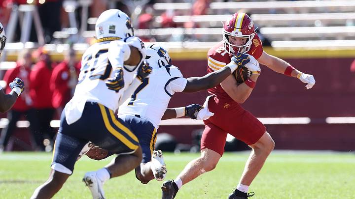 Oct 3, 2026; Ames, Iowa, USA;  West Virginia Mountaineers cornerback Geimere Latimer (1) tackles Iowa State Cyclones running back Aiden Flora (21) at Jack Trice Stadium.  Mandatory Credit: Reese Strickland-Imagn Images