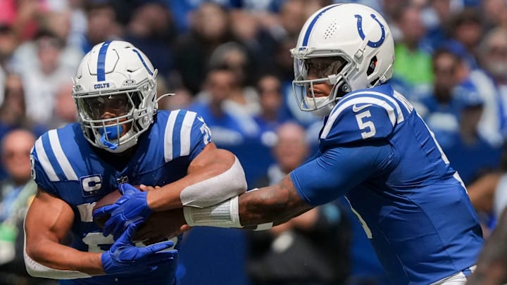 Indianapolis Colts quarterback Anthony Richardson (5) hands the ball off to Indianapolis Colts running back Jonathan Taylor (28) on Sunday, Sept. 8, 2024, during a game against the Houston Texans at Lucas Oil Stadium in Indianapolis.