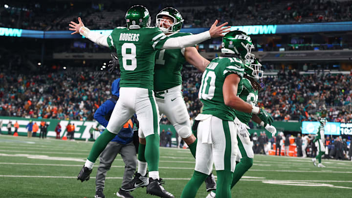 Jan 5, 2025; East Rutherford, New Jersey, USA; New York Jets quarterback Aaron Rodgers (8) celebrates his touchdown pass to New York Jets wide receiver Davante Adams (17) (not pictured) during the fourth quarter of their game against the Miami Dolphins at MetLife Stadium. Mandatory Credit: Ed Mulholland-Imagn Images