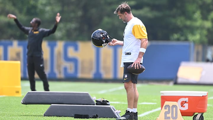 Pittsburgh Steelers quarterback Aaron Rodgers looks over his helmet during minicamp at their South Side facility. Pittsburgh Steelers quarterback Aaron Rodgers looks over his helmet during minicamp at their South Side facility.