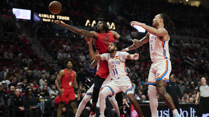 Jan 26, 2025; Portland, Oregon, USA; Portland Trail Blazers center Robert Williams III (35) reaches for a rebound during the first half against Oklahoma City Thunder guard Isaiah Joe (11) at Moda Center. Mandatory Credit: Troy Wayrynen-Imagn Images Jan 26, 2025; Portland, Oregon, USA; Portland Trail Blazers center Robert Williams III (35) reaches for a rebound during the first half against Oklahoma City Thunder guard Isaiah Joe (11) at Moda Center. Mandatory Credit: Troy Wayrynen-Imagn Images
