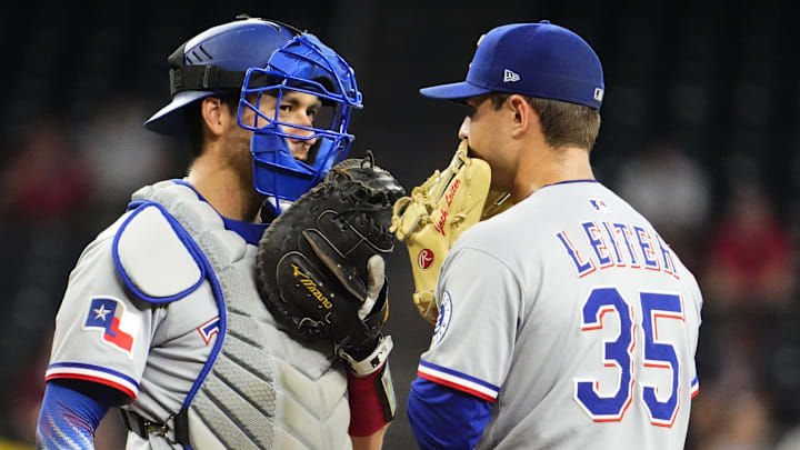 Texas Rangers catcher Kyle Higashioka talks to pitcher Jack Leiter during a game