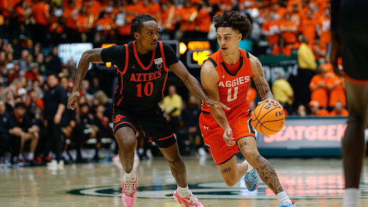 Colorado State Rams guard Kyan Evans (0) controls the ball as San Diego State Aztecs guard BJ Davis (10).