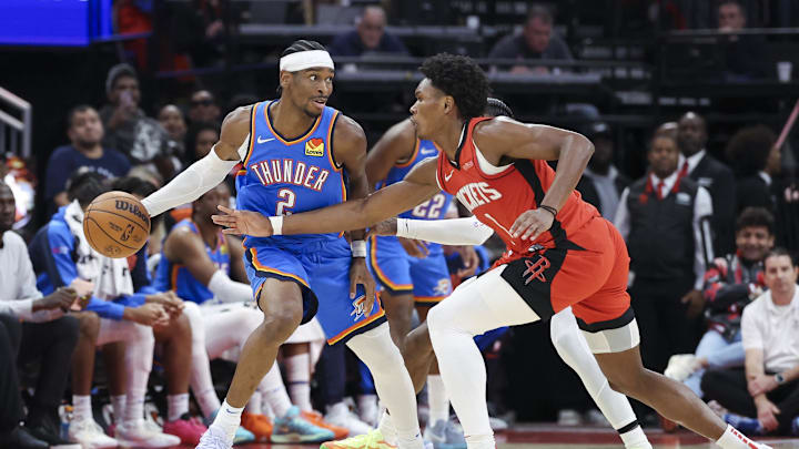 Dec 1, 2024; Houston, Texas, USA; Oklahoma City Thunder guard Shai Gilgeous-Alexander (2) controls the ball as Houston Rockets forward Amen Thompson (1) defends during the game at Toyota Center. Mandatory Credit: Troy Taormina-Imagn Images Dec 1, 2024; Houston, Texas, USA; Oklahoma City Thunder guard Shai Gilgeous-Alexander (2) controls the ball as Houston Rockets forward Amen Thompson (1) defends during the game at Toyota Center. Mandatory Credit: Troy Taormina-Imagn Images