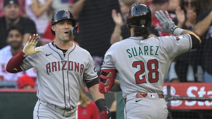 Jul 12, 2025; Anaheim, California, USA;  Arizona Diamondbacks third baseman Eugenio Suarez (28) is greeted by right fielder Randal Grichuk (15) at the dugout after hitting a solo home run during the second inning against the Los Angeles Angels at Angel Stadium. Mandatory Credit: Jayne Kamin-Oncea-Imagn Images