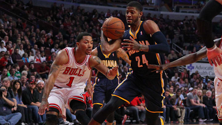 Nov 16, 2013; Chicago, IL, USA; Indiana Pacers small forward Paul George (24) drives past Chicago Bulls point guard Derrick Rose (1) during the first quarter at  the United Center. Mandatory Credit: Dennis Wierzbicki-Imagn Images