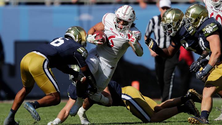 Wisconsin Badgers running back Chez Mellusi (6) is brought down by the Notre Dame defense during their football game Saturday, September 25, 2021, at Soldier Field in Chicago. Wisconsin Badgers running back Chez Mellusi (6) is brought down by the Notre Dame defense during their football game Saturday, September 25, 2021, at Soldier Field in Chicago.