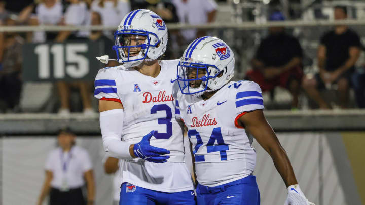 Oct 5, 2022; Orlando, Florida, USA; Southern Methodist Mustangs running back Velton Gardner (24) is congratulated by wide receiver Beau Corrales (3) after scoring a touchdown during the first quarter against the UCF Knights at FBC Mortgage Stadium. Mandatory Credit: Mike Watters-USA TODAY Sports Oct 5, 2022; Orlando, Florida, USA; Southern Methodist Mustangs running back Velton Gardner (24) is congratulated by wide receiver Beau Corrales (3) after scoring a touchdown during the first quarter against the UCF Knights at FBC Mortgage Stadium. Mandatory Credit: Mike Watters-USA TODAY Sports