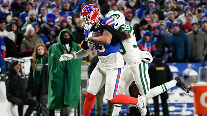 Jan 4, 2026; Orchard Park, New York, USA; Buffalo Bills wide receiver Gabe Davis (13) carries the ball after a reception defended by New York Jets cornerback Samuel Womack III (39) during the first half at Highmark Stadium.