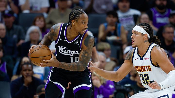 Nov 11, 2025; Sacramento, California, USA; Sacramento Kings guard DeMar DeRozan (10) controls the ball against Denver Nuggets forward Aaron Gordon (32) during the first quarter at Golden 1 Center.