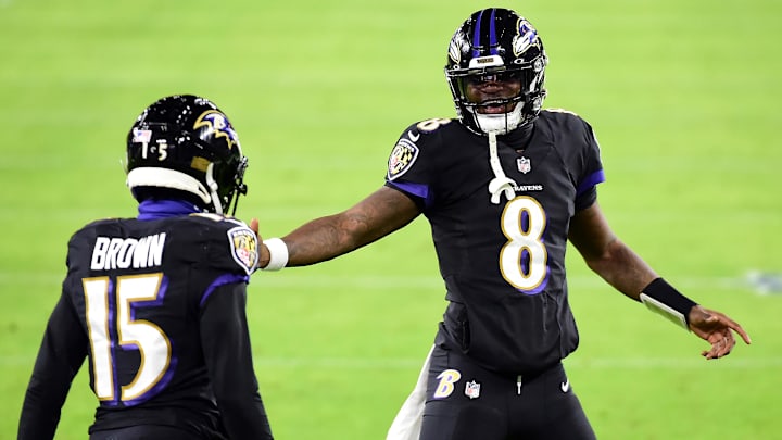 Dec 8, 2020; Baltimore, Maryland, USA; Baltimore Ravens quarterback Lamar Jackson (8) high fives wide receiver Marquise Brown (15) after a touchdown in the second quarter against the Dallas Cowboys at M&T Bank Stadium. Mandatory Credit: Evan Habeeb-Imagn Images
