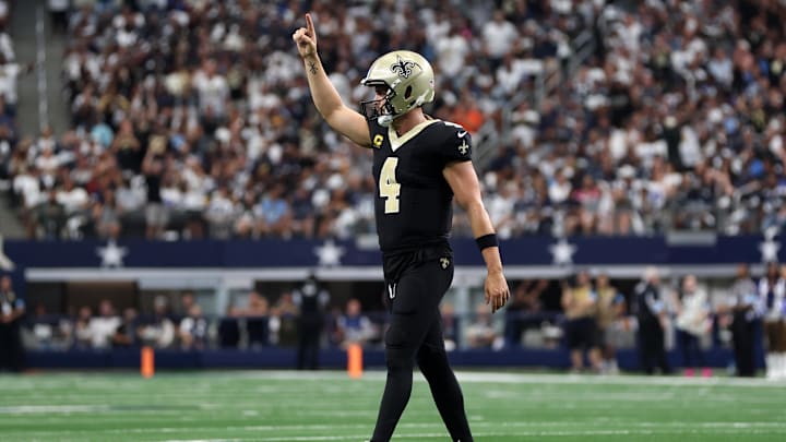 Sep 15, 2024; Arlington, Texas, USA; New Orleans Saints quarterback Derek Carr (4) reacts after a touchdown against the Dallas Cowboys in the second quarter at AT&T Stadium. Mandatory Credit: Tim Heitman-Imagn Images