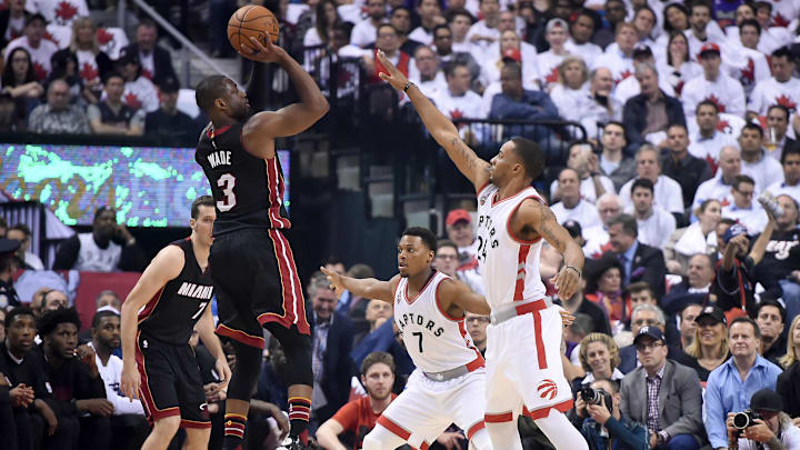 May 3, 2016; Toronto, Ontario, CAN;  Miami Heat guard Dwyane Wade (3) takes a shot over Toronto Raptors guards Norman Powell (24) and Kyle Lowry (7)  in game one of the second round of the NBA Playoffs at Air Canada Centre. Mandatory Credit: Dan Hamilton-Imagn Images