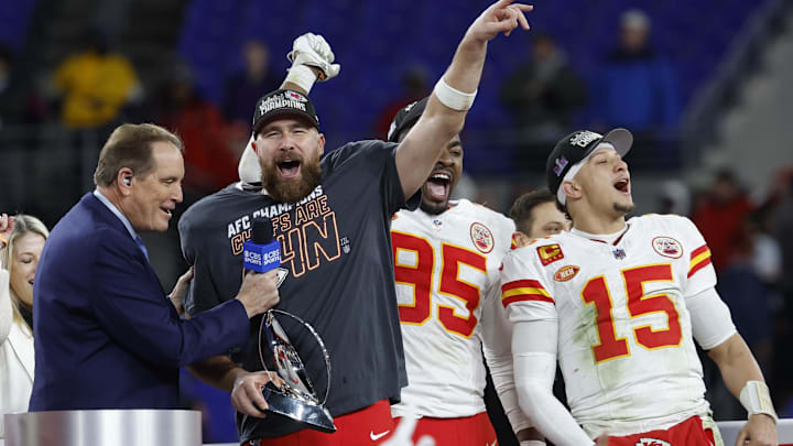 Jan 28, 2024; Baltimore, Maryland, USA; Kansas City Chiefs tight end Travis Kelce (M) celebrates with the Lamar Hunt trophy next to Chiefs defensive tackle Chris Jones (95) and Chiefs quarterback Patrick Mahomes (15) while speaking with CBS broadcaster Jim Nantz (L) after the Chiefs' game against the Baltimore Ravens in the AFC Championship football game at M&T Bank Stadium. Mandatory Credit: Geoff Burke-Imagn Images