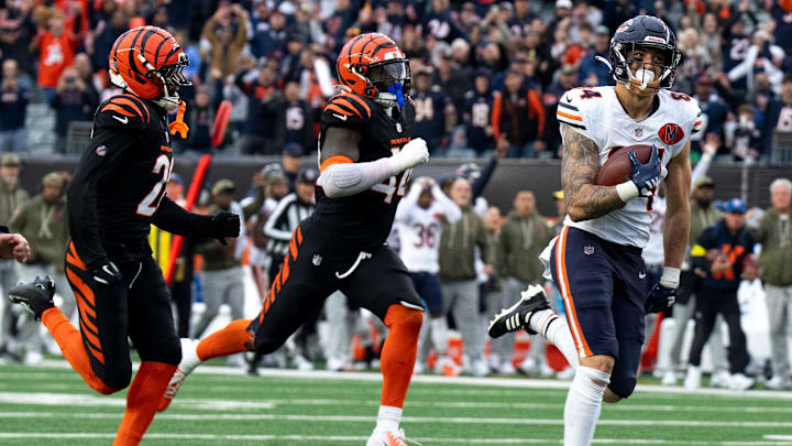 Chicago Bears tight end Colston Loveland (84) catches a pass and runs for a go ahead touchdown as Cincinnati Bengals linebacker Demetrius Knight Jr. (44) and Cincinnati Bengals cornerback Josh Newton (28) attempt to stop him in the fourth quarter of the NFL football game between Chicago Bears and Cincinnati Bengals at Paycor Stadium in Cincinnati on Nov. 2, 2025.