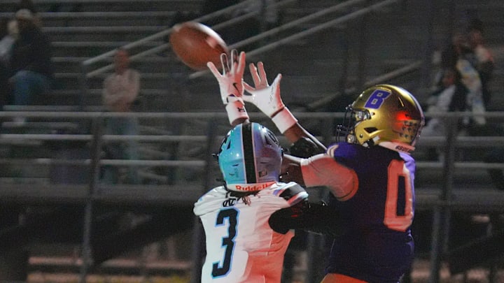 Booker High wide receiver Chauncey Kennon (#0) is unable to make the sideline catch, guarded by Nature Coast Tech cornerback Trent Montgomery (#3). The Booker Tornadoes hosted Nature Coast Tech in the Class 3A-Region 3 regional semifinal game Friday night in Sarasota.