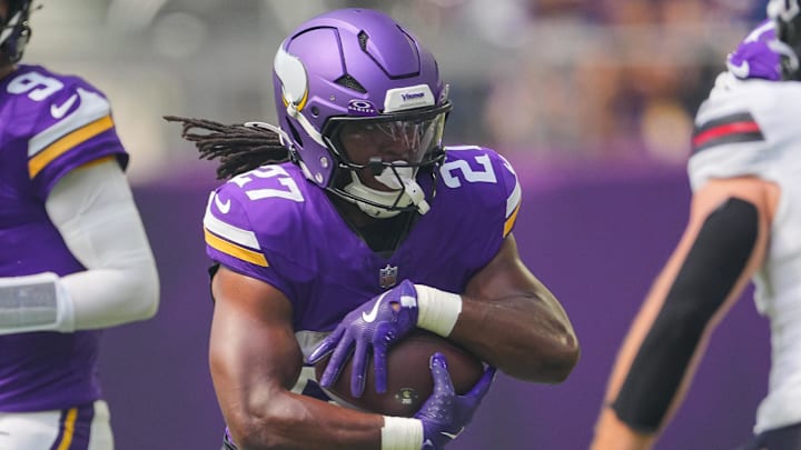 Aug 9, 2025; Minneapolis, Minnesota, USA; Minnesota Vikings running back Jordan Mason (27) runs with the ball against the Houston Texans in the first quarter at U.S. Bank Stadium. Mandatory Credit: Brad Rempel-Imagn Images