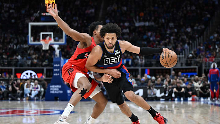 Jan 11, 2025; Detroit, Michigan, USA;  Detroit Pistons guard Cade Cunningham (2) drives past Toronto Raptors forward Scottie Barnes (4) in the second quarter at Little Caesars Arena. Mandatory Credit: Lon Horwedel-Imagn Images