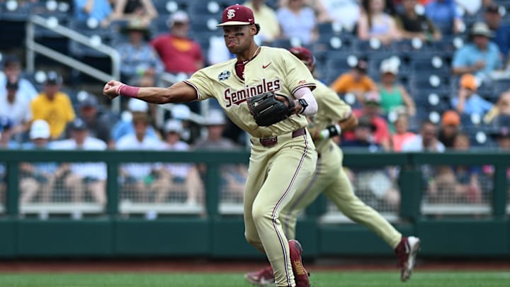 Jun 18, 2024; Omaha, NE, USA; Florida State Seminoles third baseman Cam Smith (24) throws to first base against the North Carolina Tar Heels during the first inning at Charles Schwab Field Omaha.