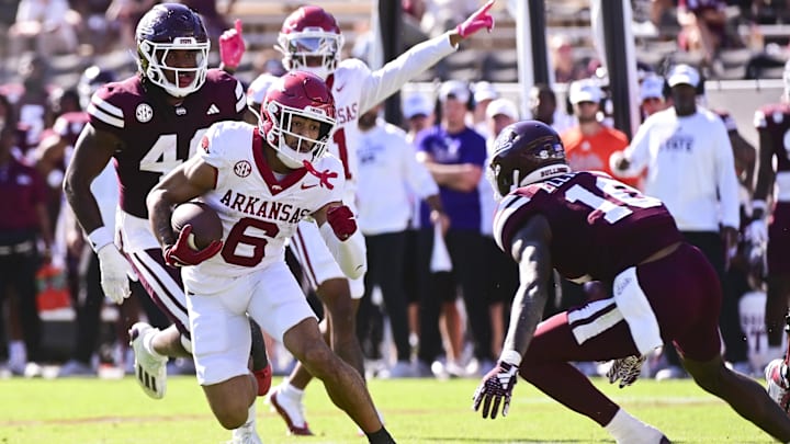 Oct 26, 2024; Starkville, Mississippi, USA; Arkansas Razorbacks wide receiver Isaiah Sategna (6) runs the ball while defended by Mississippi State Bulldogs safety Corey Ellington (10) during the fourth quarter at Davis Wade Stadium at Scott Field. Mandatory Credit: Matt Bush-Imagn Images