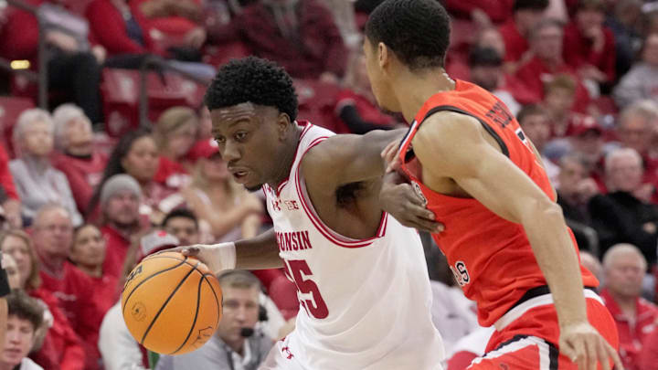 Wisconsin guard John Blackwell (25) turns the corner on Campbell guard Cam Gregory (7) during the second half of their game Monday, November 3, 2025 at the Kohl Center in Madison, Wisconsin.