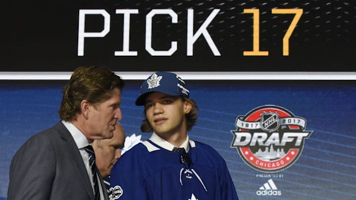 June 23, 2017; Chicago, IL, USA; Timothy Liljegren (right) speaks with head coach Mike Babcock after being selected as the number seventeen overall pick to the Toronto Maple Leafs in the first round of the 2017 NHL Draft at the United Center. Mandatory Credit: David Banks-Imagn Images