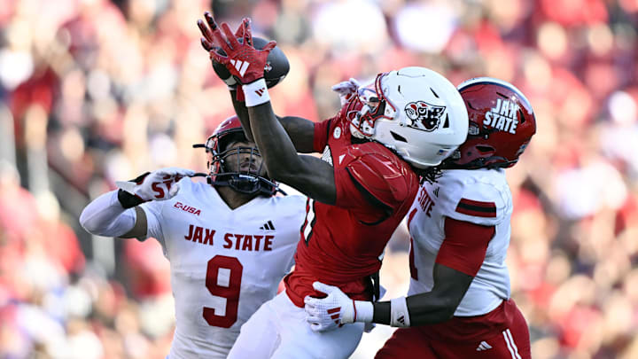 Sep 7, 2024; Louisville, Kentucky, USA; Louisville Cardinals wide receiver Cataurus Hicks (81) catches a pass under the pressure of Jacksonville State Gamecocks cornerback Geimere Latimer (1) and Jacksonville State Gamecocks safety Pat Taylor (9) during the second half at L&N Federal Credit Union Stadium. Louisville defeated Jacksonville State 49-14. Mandatory Credit: Jamie Rhodes-Imagn Images Sep 7, 2024; Louisville, Kentucky, USA; Louisville Cardinals wide receiver Cataurus Hicks (81) catches a pass under the pressure of Jacksonville State Gamecocks cornerback Geimere Latimer (1) and Jacksonville State Gamecocks safety Pat Taylor (9) during the second half at L&N Federal Credit Union Stadium. Louisville defeated Jacksonville State 49-14. Mandatory Credit: Jamie Rhodes-Imagn Images