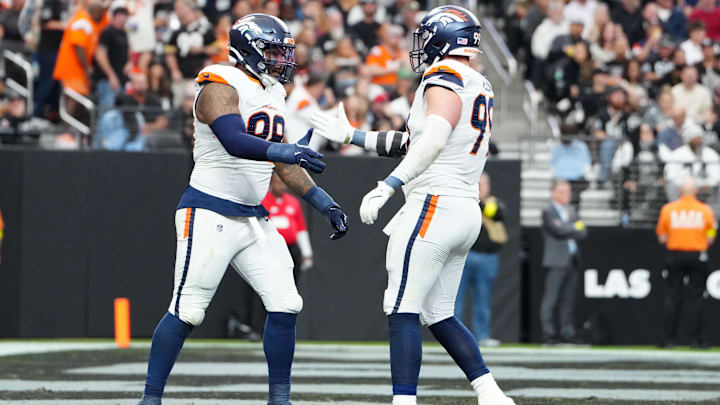 Dec 7, 2025; Paradise, Nevada, USA;  Denver Broncos defensive end John Franklin-Myers (98) and defensive end Zach Allen (99) react after a sack against the Las Vegas Raiders during the first half at Allegiant Stadium. Mandatory Credit: Stephen R. Sylvanie-Imagn Images