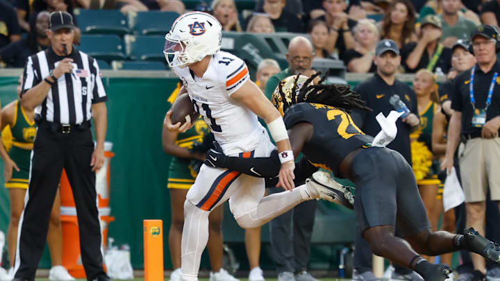 Aug 29, 2025; Waco, Texas, USA;  Auburn Tigers quarterback Jackson Arnold (11) runs the ball for a touchdown against Baylor Bears cornerback Calvin Simpson-Hunt (28) during the first half at McLane Stadium. Mandatory Credit: Chris Jones-Imagn Images