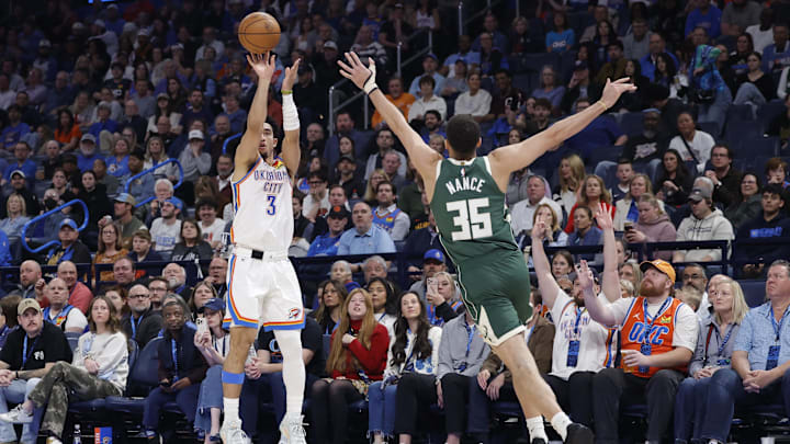 Feb 12, 2026; Oklahoma City, Oklahoma, USA; Oklahoma City Thunder guard Jared McCain (3) shoots a three point basket as Milwaukee Bucks forward Pete Nance (35) defends during the second half at Paycom Center. Mandatory Credit: Alonzo Adams-Imagn Images