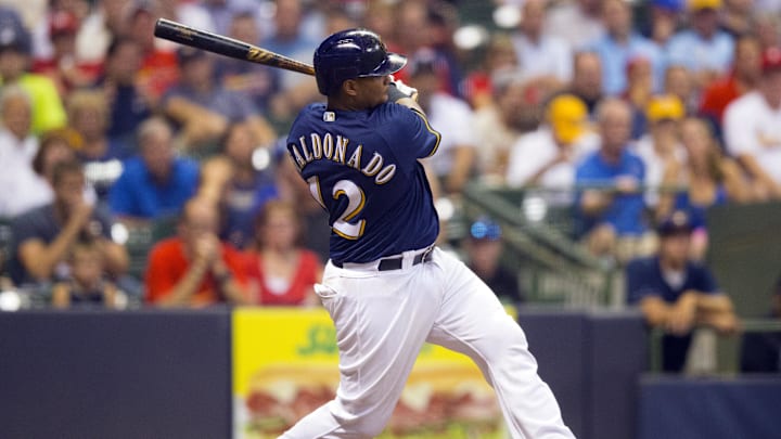 Aug 30, 2016; Milwaukee, WI, USA;  Milwaukee Brewers catcher Martin Maldonado (12) hits an RBI double during the sixth inning against the St. Louis Cardinals at Miller Park. Mandatory Credit: Jeff Hanisch-Imagn Images