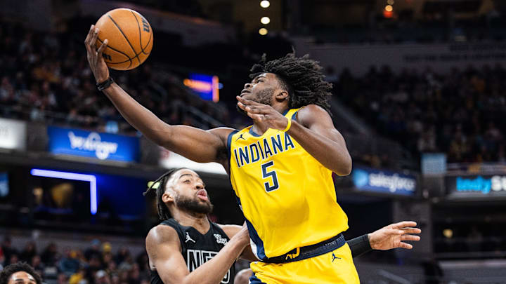 Mar 20, 2025; Indianapolis, Indiana, USA; Indiana Pacers forward Jarace Walker (5) shoots the ball while Brooklyn Nets forward Trendon Watford (9) defends in the first half at Gainbridge Fieldhouse. Mandatory Credit: Trevor Ruszkowski-Imagn Images