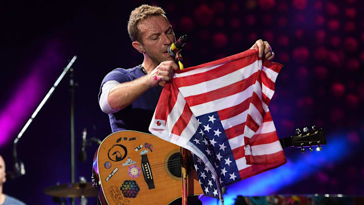 Aug 28, 2017; Miami Gardens, FL, USA; Chris Martin of Coldplay performs with an American flag at the Hard Rock Stadium. Mandatory Credit: Ron Elkman/USA TODAY NETWORK Aug 28, 2017; Miami Gardens, FL, USA; Chris Martin of Coldplay performs with an American flag at the Hard Rock Stadium. Mandatory Credit: Ron Elkman/USA TODAY NETWORK